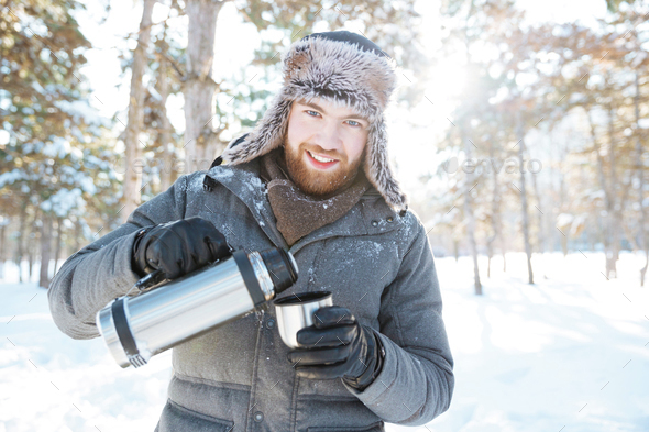 Thermos and Metal Cup with Hot Tea on a Snow-covered Bench in a Winter Park  Stock Photo - Image of space, flask: 161501460