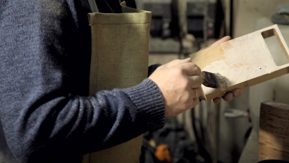 Woodworker Applying Glue To Boards