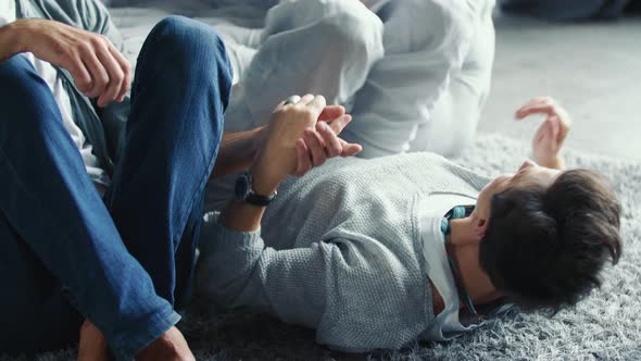 Aged Couple Sitting Near the Sofa alt