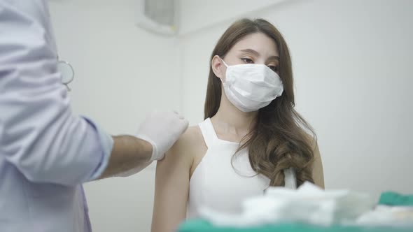 Doctor holding syringe and giving injection  vaccine and medical cosmetic to woman at hospital alt