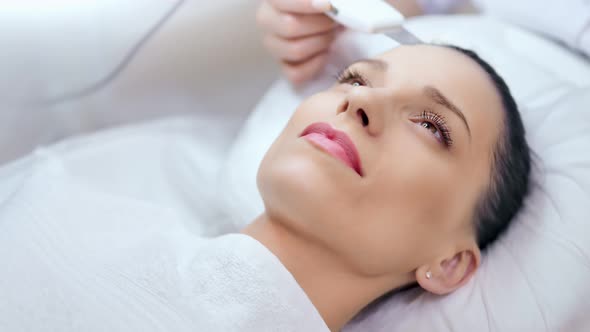 Closeup Etalon Female Young Face with Perfect Skin During Ultrasonic Peeling at Beauty Salon alt