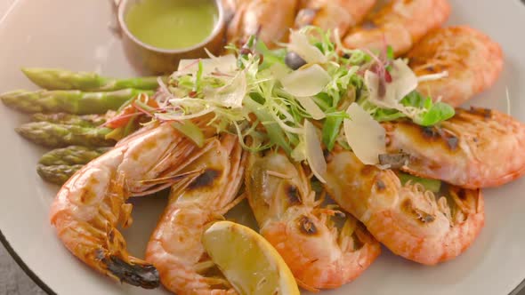 Top view of roasted shrimps served with asparagus