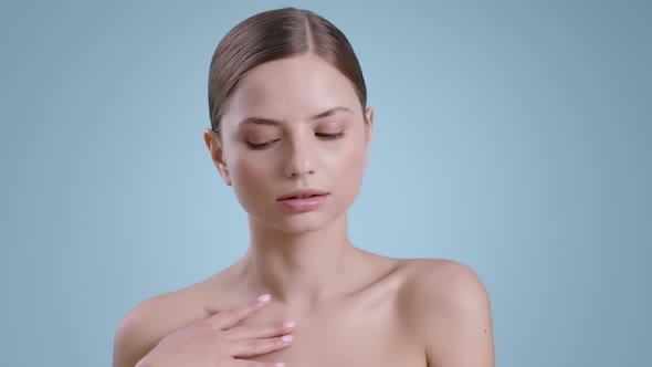 Beautiful Young Woman Touching Her Naked Shoulders and Turning Head  alt