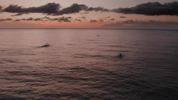 Aerial View of Sunrise Above Ocean with Dark Silhouettes of Fishing Boats Going for Fishery