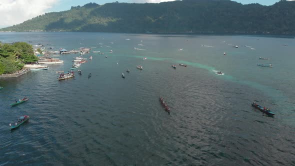 Aerial: kora-kora traditional canoe annual race in the Banda Islands Indonesia alt