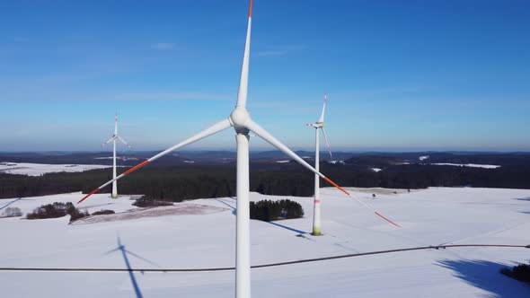 Orbiting a wind power plant with a drone. Circling a wind power plant in the air. 