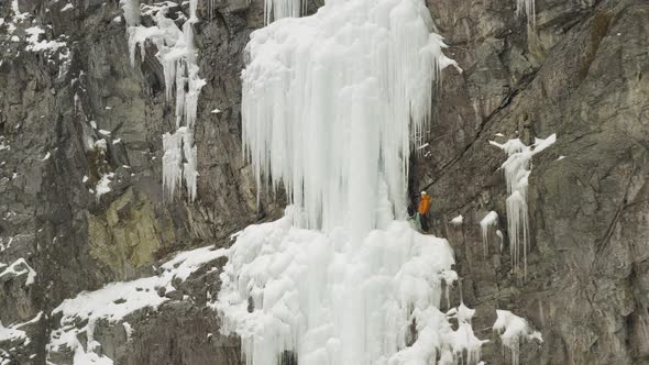 Climber on Sheer frozen cascade off Mount Kineo, Maineline alt