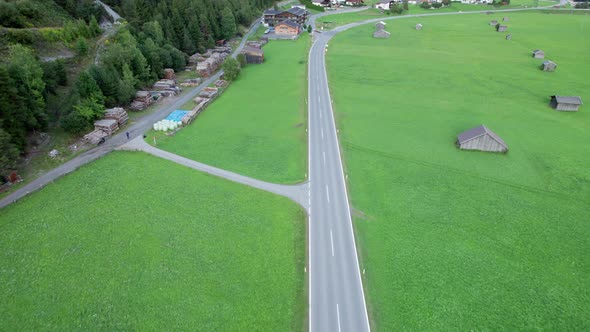Empty Asphalt Road in Austria Between Green Fields in the Alps Aerial View alt