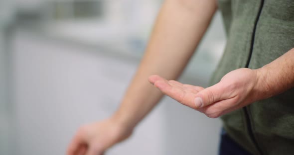 Man Disinfecting Hands with Antibacterial Gel alt
