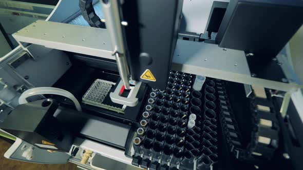 Coronavirus, Covid-19 Laboratory Test. Biochemical Analyzer Is Working with Test Tubes and Fluids alt