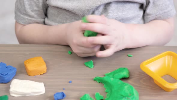 Close up of kids hands molding colorful childs play clay