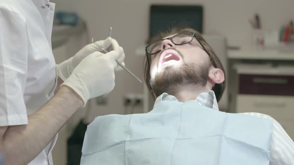 Dentist examines the patient in the office