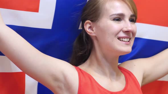 Norwegian Young Woman Celebrates Holding the Flag of Norway alt