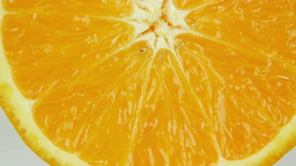 Close Up Slice of Orange Rotating. Semicircle of Juicy Orange alt