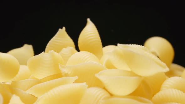 Macro shot of falling of conchiglie (pasta) on a heap
