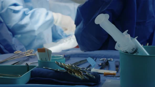 Surgeons working during open heart surgery, close up on hands and instruments. alt