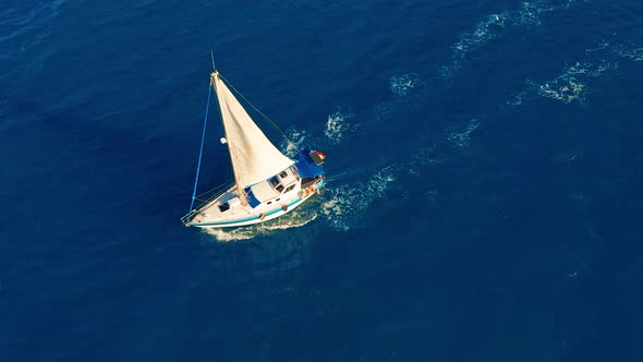 Aerial View. Yacht Sailing on Open Sea at Sunny Day. Sailing Boat alt
