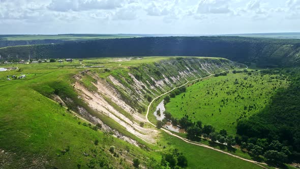 Aerial drone view of nature, green valley with river, hills, forest, Moldova alt