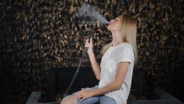 Medium Shot of Young Attractive Woman in Hookah Bar alt