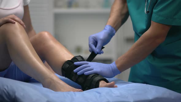 Doc Fixing Two-Strap Ankle Wrap in Proper Position Anti-Inflammatory Medication