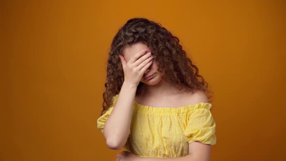 Tired Sleepy Young Curly Woman Yawning Against Yellow Background