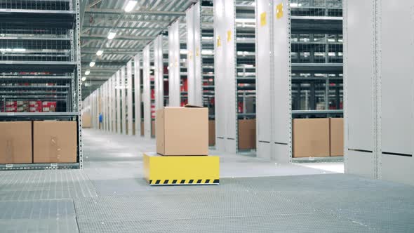 Automated Vehicle is Transporting a Package Through the Storage alt