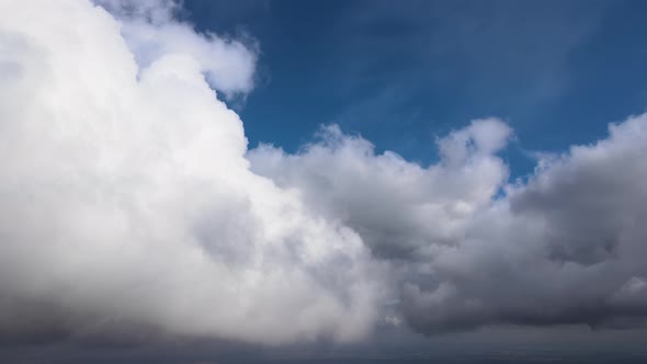 Aerial View From Airplane Window at High Altitude of Earth Covered with Puffy Cumulus Clouds Forming alt