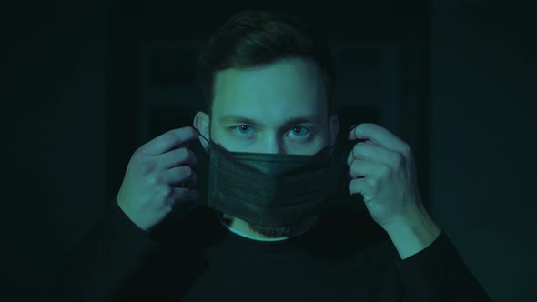 Pandemic, Portrait of a Young Man Wearing Protective Mask in Neon Light