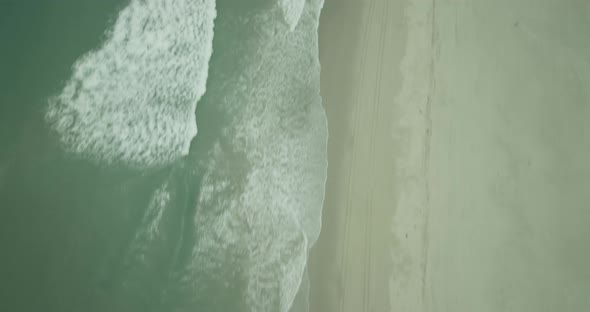 Helicopter aerial shot of beautiful Malibu beach houses, overcast day