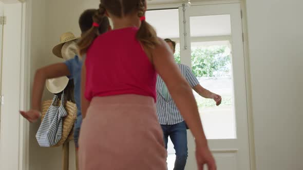 Caucasian happy son and daughter running to father coming home, embracing and welcoming alt
