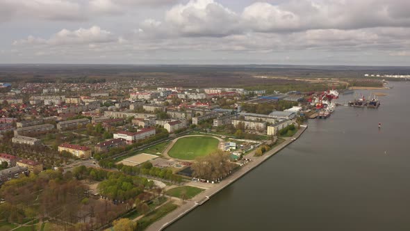 Aerial view of the stadium near port in Svetliy town alt