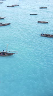 Vertical Video Boats in the Ocean Near the Coast of Zanzibar Tanzania alt