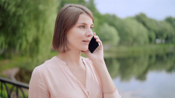 Young Woman Talking By Phone on the Run
