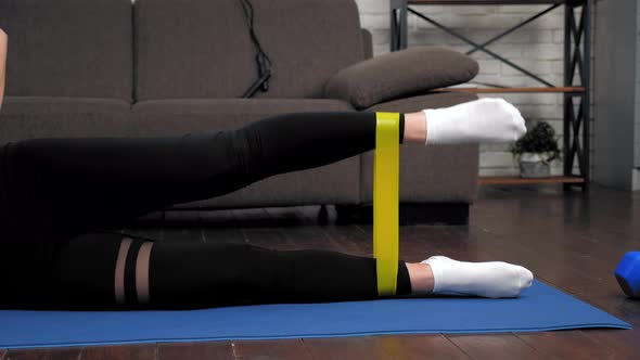 Athletic Muscular Woman Doing Legs Exercise with Loop Band on Fitness Yoga Mat alt