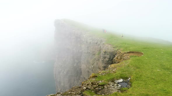 Beautiful View of Foggy Traelanipan Slave Mountain in Vagar Faroe Islands alt