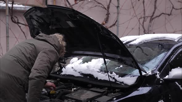 Man Open Hood of the Car and Trying To Find Out What Is Happened with Car alt