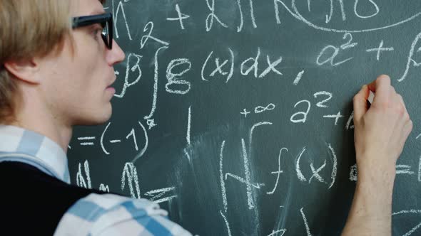 Young Mathematician Writing Formulas on Chalkboard Working with Serious ...