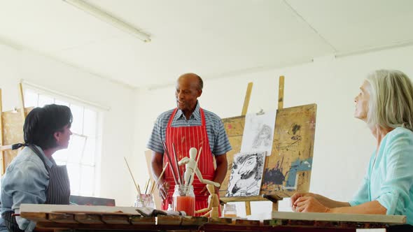 Artists working together at table 4k alt