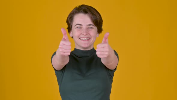 Positive young girl posing isolated on yellow studio background. alt