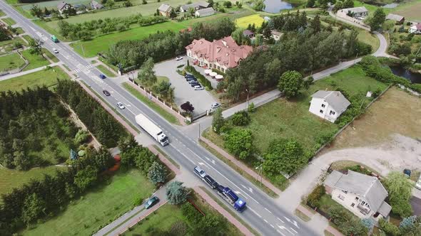 An Aerial Over a Charming Small Village Scene with Road and Hotel. alt