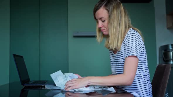 Woman Calculating Payment Bill in Kitchen alt