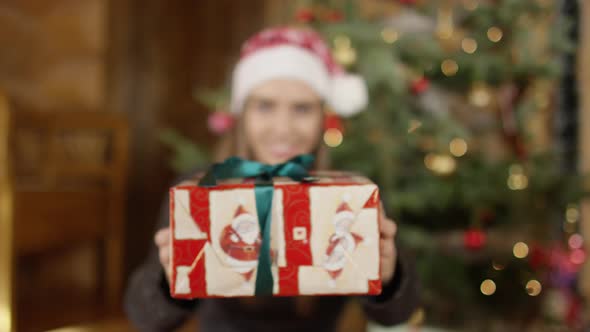 Woman holding a Christmas gift alt