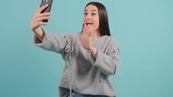 Young Woman Greets Friends During Online Conversation. alt