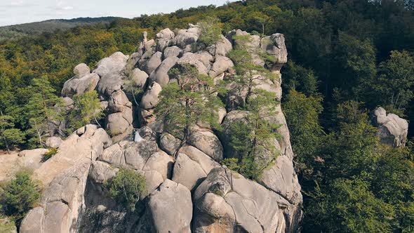Wedding Couple in Mountain Rock From Drone. Aerial View Happy Newlyweds in Love Hugging Standing on alt