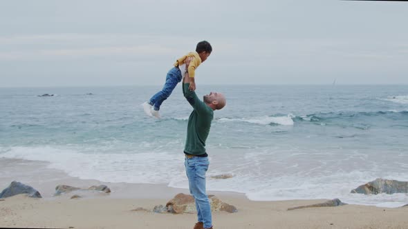 Father Is Spending Time With Son On Beach
