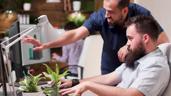 Dolly Shot of Architects Using 3D Software To Discuss New Buildings alt