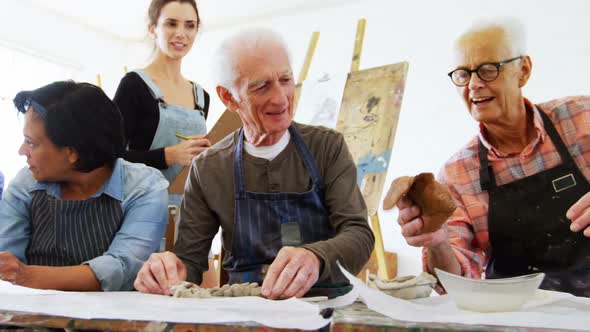 Woman assisting artists in pottery 4k alt