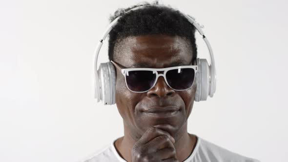 Mid-Aged African Man Listening to Music with Headphones alt