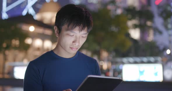 Man Use of Tablet Computer at Night alt