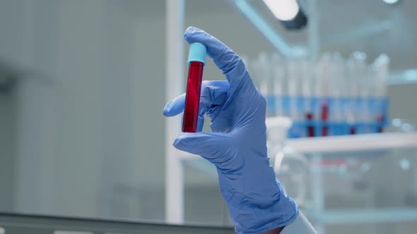 Close Up of Glass Vacutainer Filled with Dna Solution alt